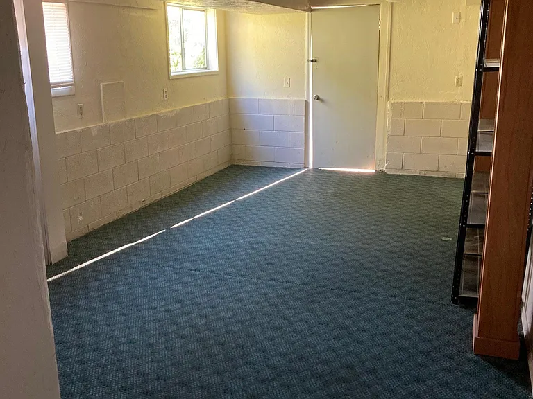 Downstairs family type room. Door leads to the back yard and deck