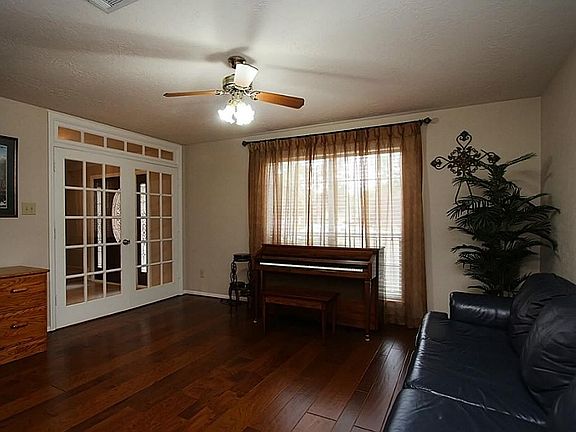 Another view of the formal living room showing the glass French doors, enabling this room to serve as an office/study or game room.