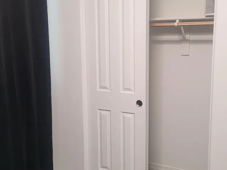 Bedroom includes a sliding-door closet with hanging rod and shelf storage, plus tile flooring for easy upkeep.