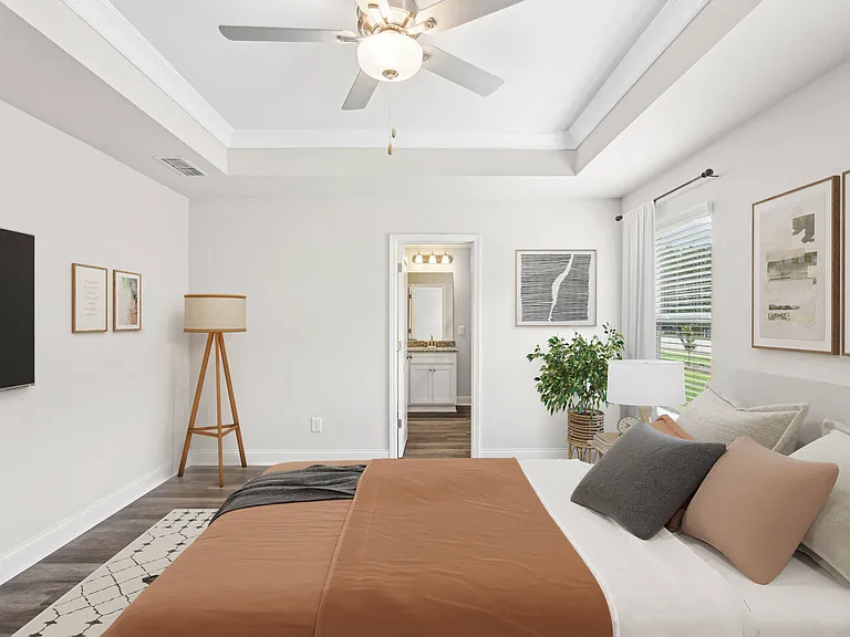 Primary Bedroom with king size bed and large window letting in nice natural light.