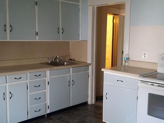 Kitchen leading to bath and back bedroom or dining room