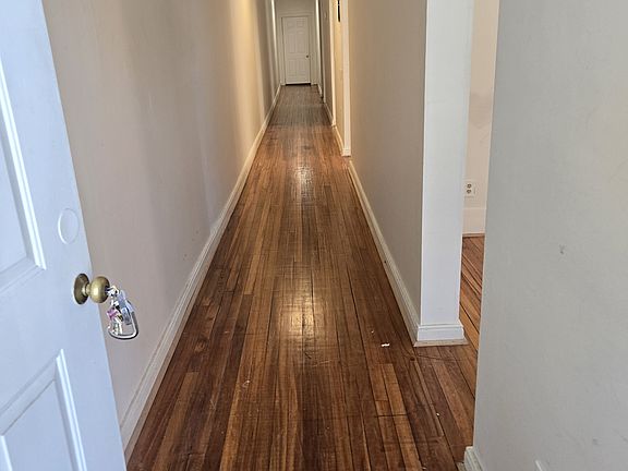 Front door view. Long hallway, rooms located on the right side.