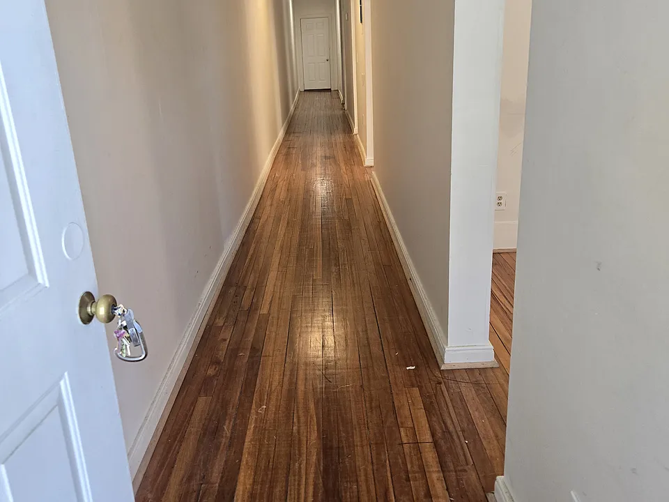Front door view. Long hallway, rooms located on the right side.