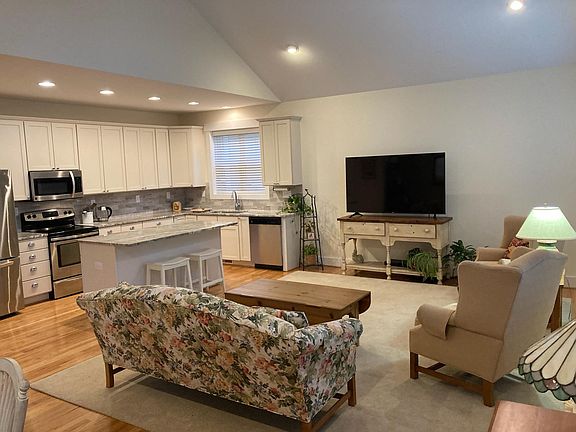 Kitchen and Great Room with vaulted ceiling. Naturally finished red oak hardwood floors.