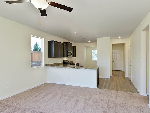 Everyone will enjoy gathering at the long breakfast bar in the modern kitchen