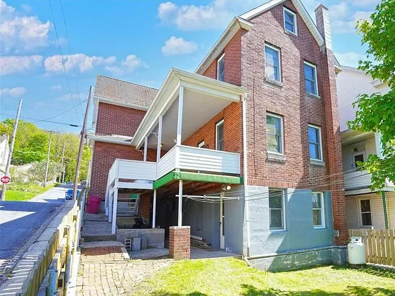 Lots of space in a grand house with tons on natural light flooding in the windows on a corner lot!