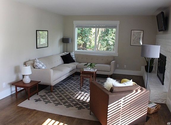 Beautiful oak floors, wood burning fireplace and vinyl windows.  Notice the wide base trim and wrapped windows.