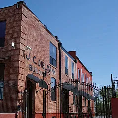 Main building entrance and gated parking lot.