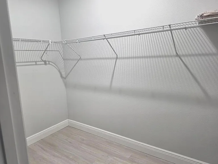 Dedicated walk-in closet with wire shelving and hanging storage to keep wardrobes and linens organized.
