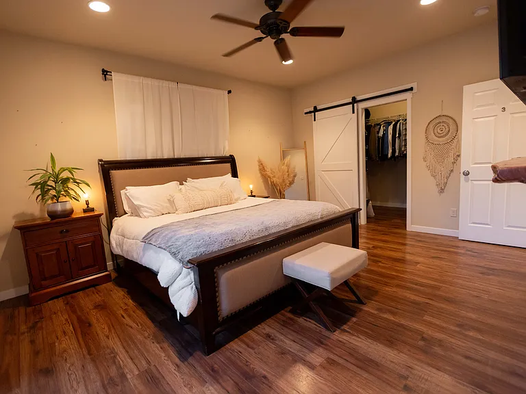 Master bedroom has dimmable lights, a fan, and also includes a very large walk in closet on right side of bedroom