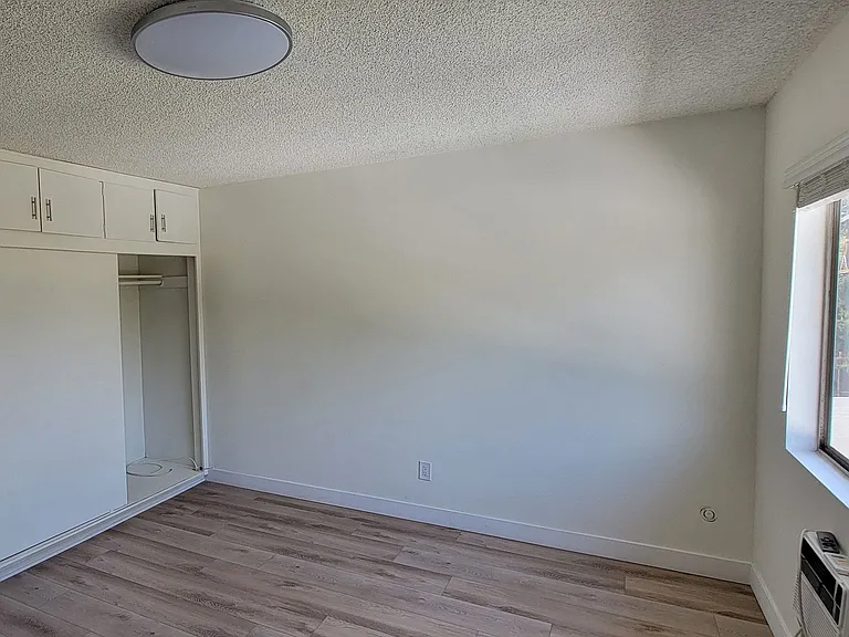 Large bedroom with lots of closet space in 2-bedroom apartment at the Hardison Apartments.