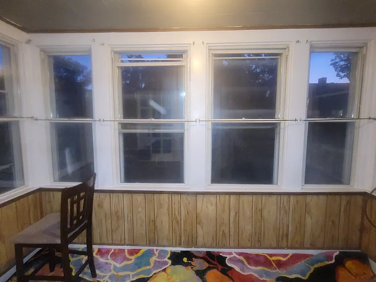 Enclosed Balcony off Kitchen! Makes a Lovely sitting area with lots of plants!