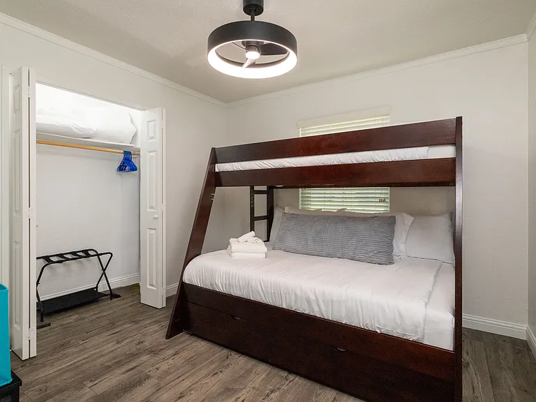 Bedroom 2 features a bunk bed with a double bed and single bed on top as well as flat-screen Roku TV, children books and kids games, perfect for the kiddos! There is also a spacious closet with a luggage rack and hangers for plenty of storage.