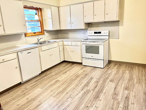 Kitchen with new flooring, dish washer & range plus a ton of cabinet space.