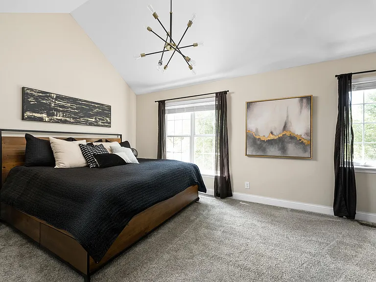 Primary Suite with Vaulted ceilings, with attached bathroom and walk in closet.