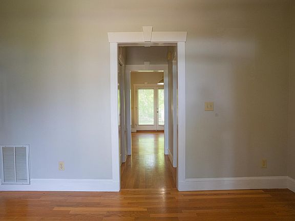 Foyer leading to powder room and kitchen