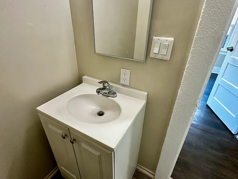Full sized bathroom with bathtub, and real glass shower doors.