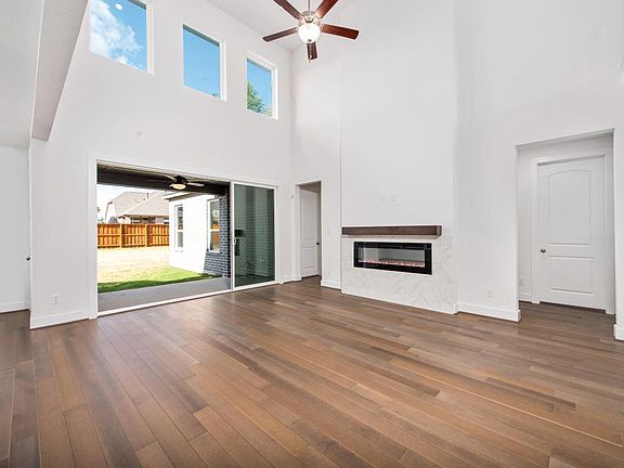 Spacious great room with fireplace and multi-slide doors to patio