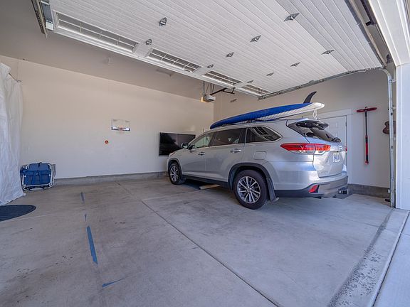 Two car garage with 9 foot tall garage door and long driveway with room for two cars