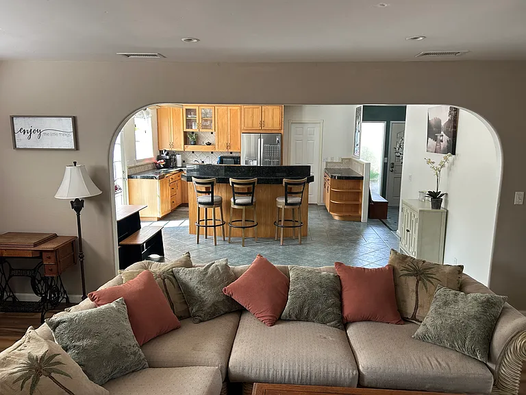 Living room looking into kitchen and dining room table.