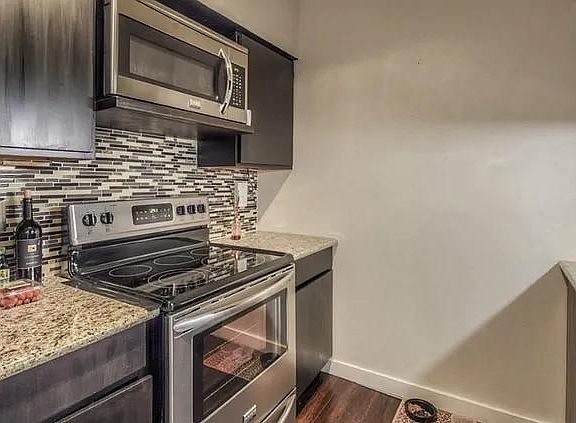 Galley kitchen with stainless steel appliances.