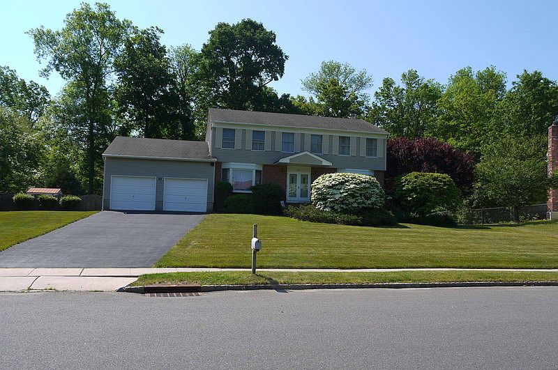 Curbside Appeal : Large center hall colonial with two car garage and bay windows