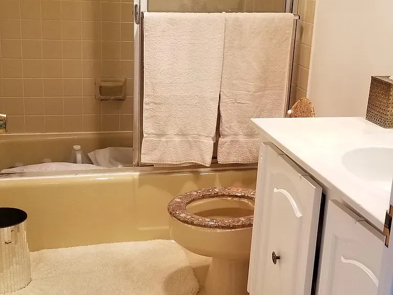 Spacious bathroom with large vanity, enclosed shower and bathtub.