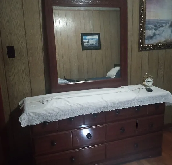 Bedroom: sturdy dresser with mirror.