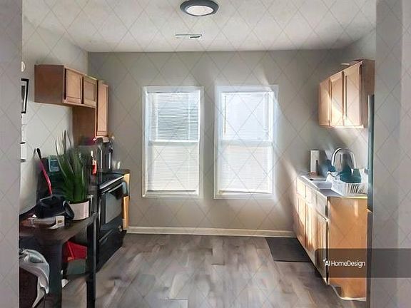 Kitchen w/plenty of natural light! Photo is of current tenants decor. Will be updated!!