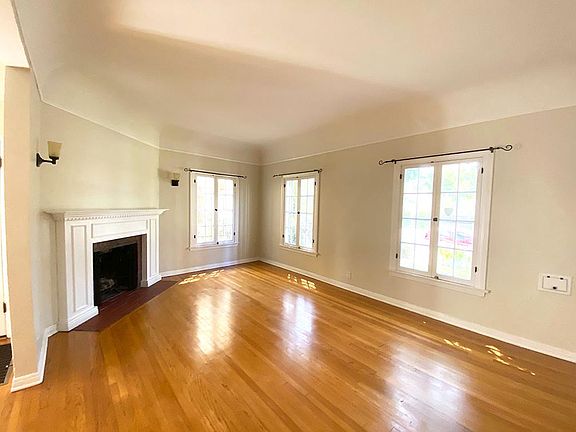 Living room with wood-burning fireplace.
