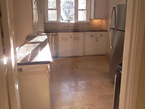 Super sunny kitchen w Travertine floors, under cabinet light