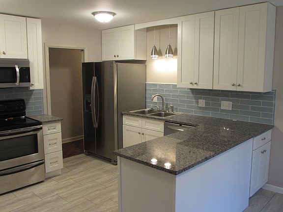 Kitchen features new stainless appliances, granite countertop and new cabinets.
