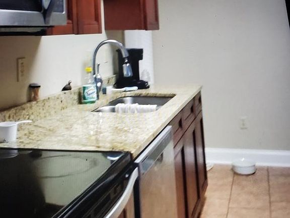 Kitchen with granite tops and stainless steel appliances...