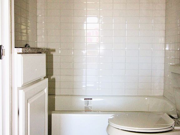 Upgraded bathroom with tub and vinyl plank flooring