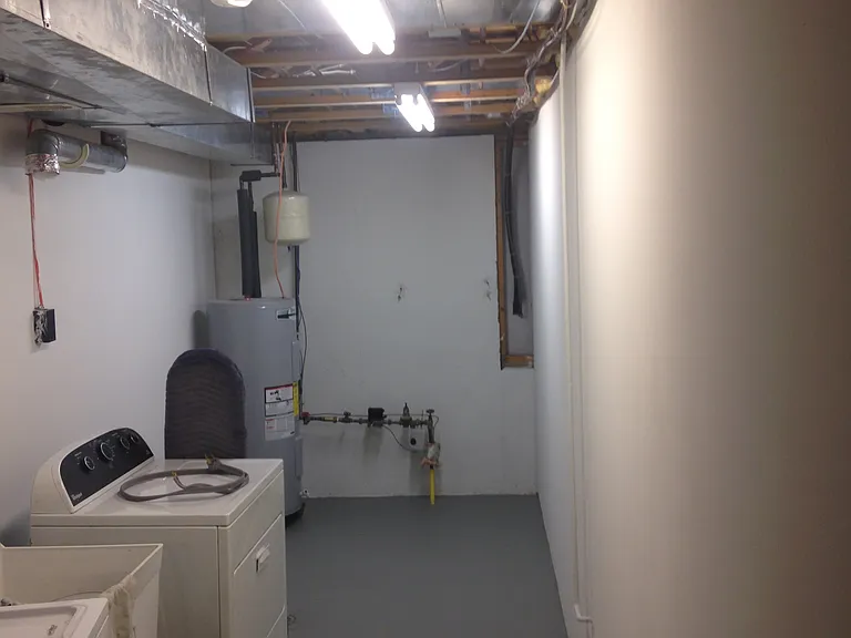 Spacious laundry room that includes washer, dryer & laundry tub