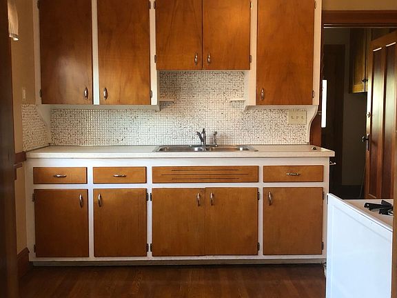 Beautiful retro wood cabinets compliment the original hardwood floor creating a cozy and elegant environment.