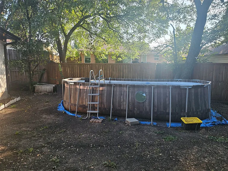 View of pool with a fenced backyard