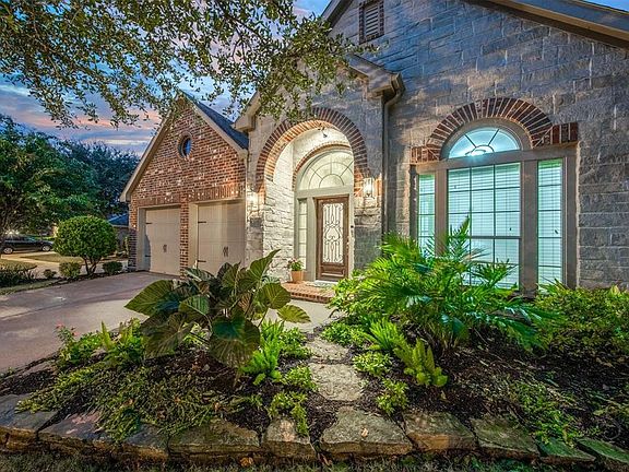 The pristine home features four bedrooms, 3 and 1/2 baths, a spacious study with French doors at the front of the house, game room with French doors , open concept kitchen/living area and a gorgeous outdoor living space!