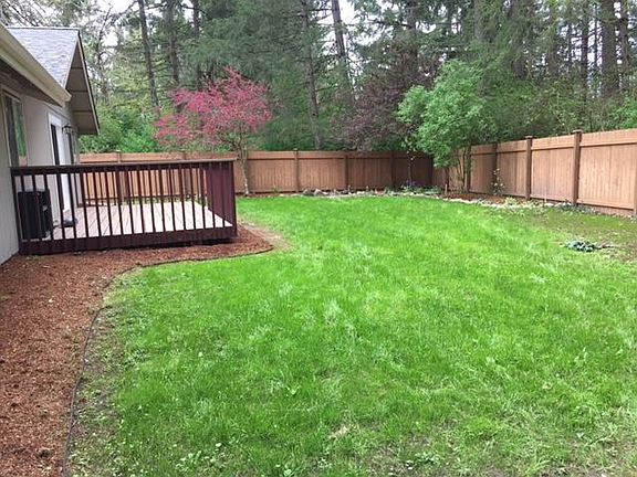 Backyard with deck to left and patio to right