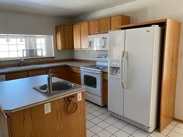 Handy island with storage and a prep sink. Plenty of storage here!
