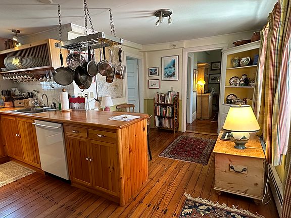 Wide angle view of the kitchen as you come in from the mud room. Door at the far end is into the Dining Room, and door to the far left into the Main Bathroom.