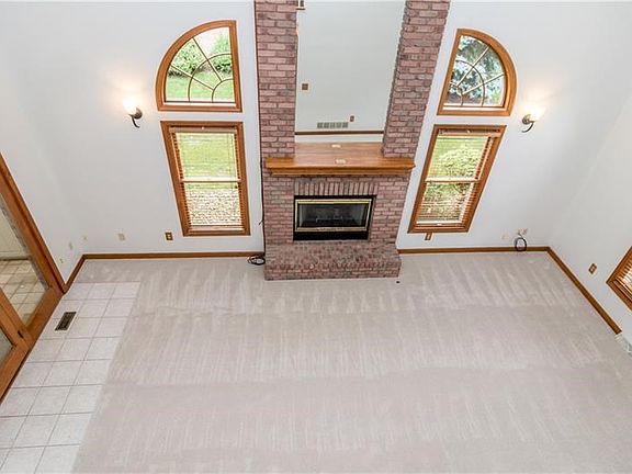 Floor to ceiling fireplace, flanked by windows, for lots of natural lighting.