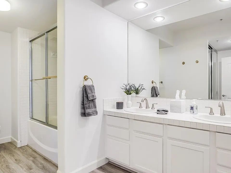 Bathroom, oval soaking tub, dual-sink vanity, ample and clean counter space. storage closet.