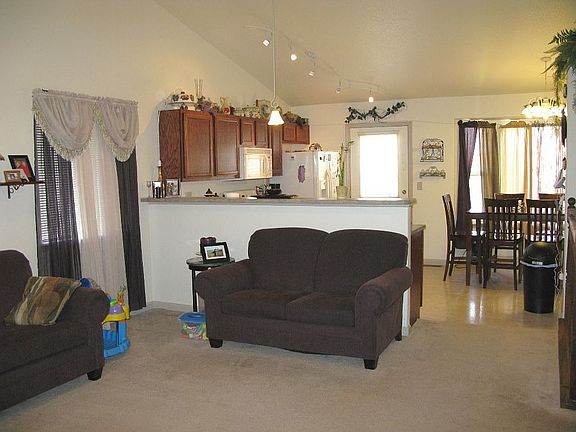 View of great room, kitchen and dining room - with vaulted ceilings