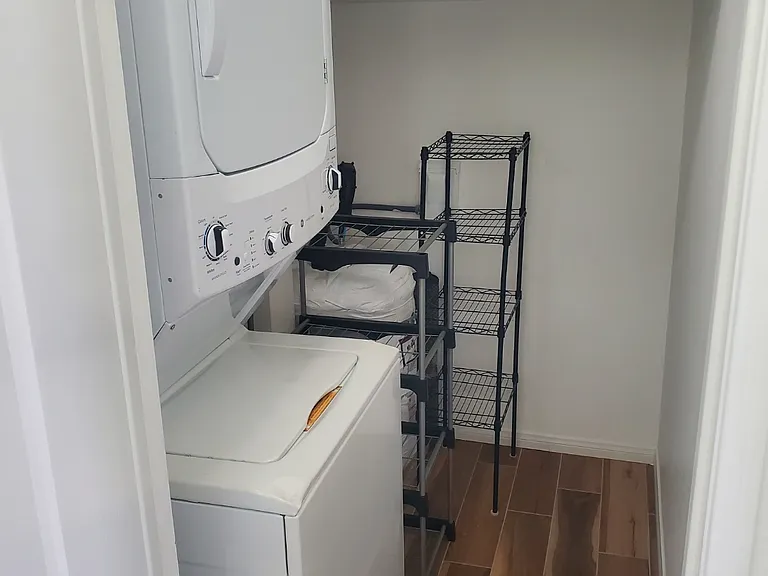 In unit full size washer and dryer, iron and mini ironing board included.