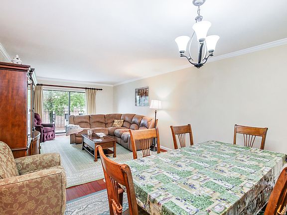 Dining room facing living room and entry to balcony
