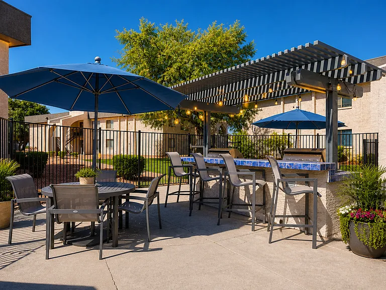 Sunny poolside patio with outdoor dining