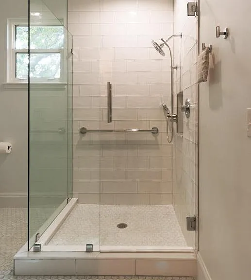 Frameless glass shower enclosure