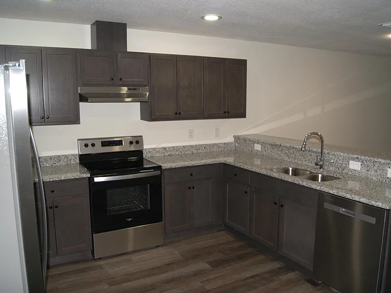 Another angle of kitchen with large countertops