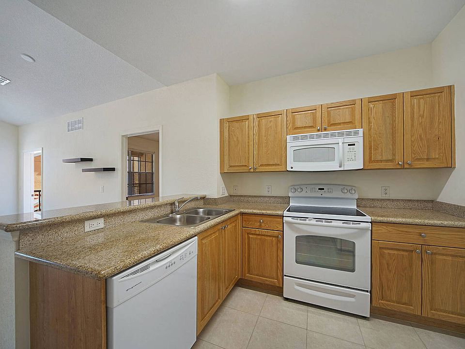 Kitchen w/ granite counters and wooden cabinets